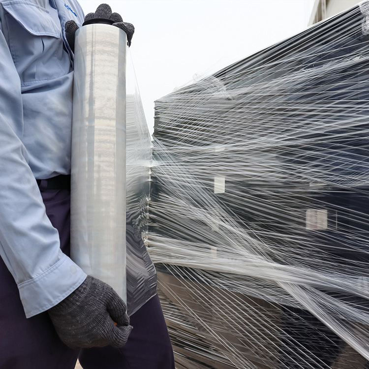 Warehouse logistics and stretch wrapped pallets ready for transport